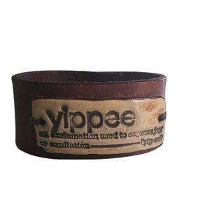 Leather cuff bracelet with ceramic piece reading "yippee ...